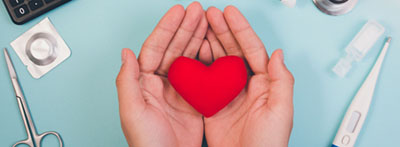 Hands holding plush heart.