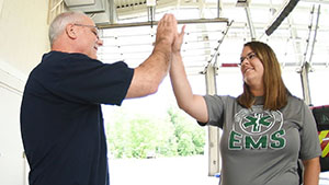 Kyil McCauley high fives paramedic Chandra Williams 